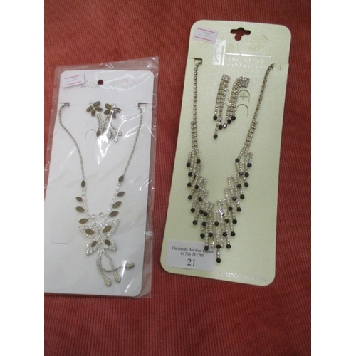 21 - 2 DIAMANTE NECKLACE AND EARRING SETS ONE WITH TINY BLACK STONES THE OTHER IS A BUTTERFLY WITH BROWN ... 