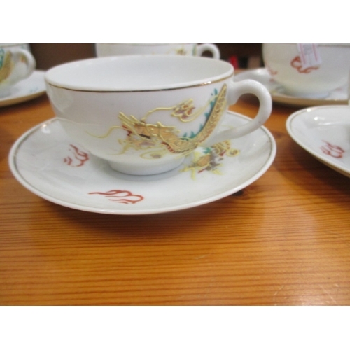 391 - 10 CHINESE CUPS AND SAUCERS DECORATED IN A DRAGON DESIGN