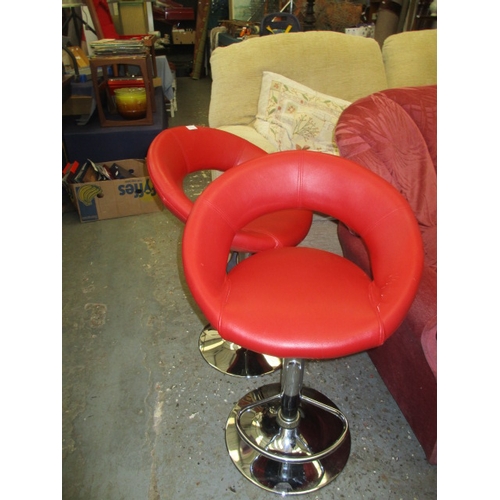 215A - PAIR OF RETRO RED VINYL BUCKET SEAT STOOLS ON CHROME PEDESTAL AND FOOTBAR