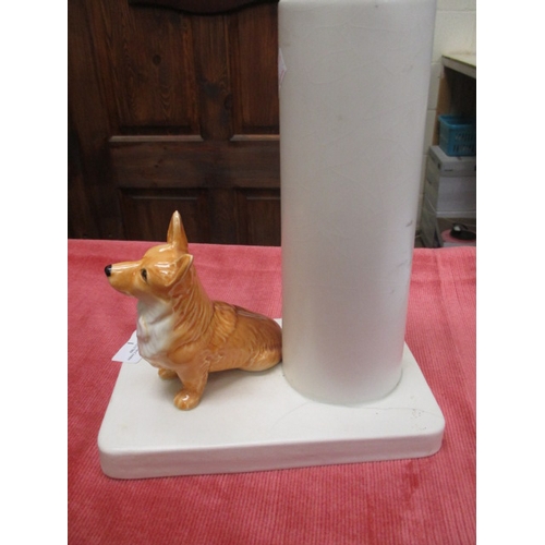 1 - SYLVAC CORGI ON PORCELAIN PLINTH WITH VASE. A/F TO BASE