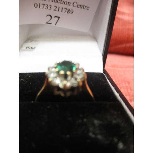 27 - 9CT GOLD RING WITH A GREEN CENTRE STONE SURROUNDED BY CLEAR STONES, SIZE L