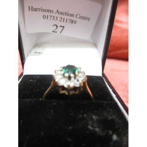 27 - 9CT GOLD RING WITH A GREEN CENTRE STONE SURROUNDED BY CLEAR STONES, SIZE L