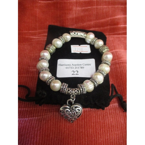 22 - A SILVER COLOURED AND FRESH WATER PEARL FASHION BRACELET (FRESH WATER PEARLS CULTURED FROM OYSTERS O... 