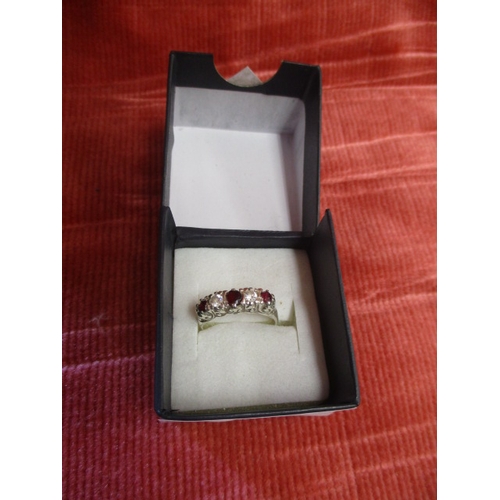 42 - SILVER COLOURED DRESS RING WITH RED AND WHITE STONES SIZE N