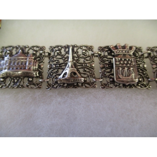 49 - SILVER COLOURED FILIGREE BRACELET DEPICTING FAMOUS FRENCH MONUMENTS INCLUDING EIFFEL TOWER, MONTMART... 