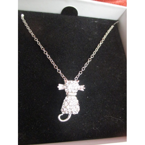 55 - SILVER COLOURED CHAIN WITH CAT PENDANT WITH WHITE STONES BOXED