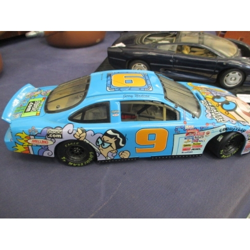 175 - JAGUAR XJ220 MODEL AND A CARTOON ADVERTISING NETWORK RACE CAR MODEL