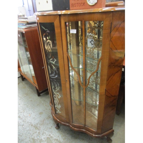 410 - WALNUT VENEERED BOW FRONTED DISPLAY CAINET WITH GLASS SHELVES.  SET ON QUEEN ANNE LEGS WITH KEY