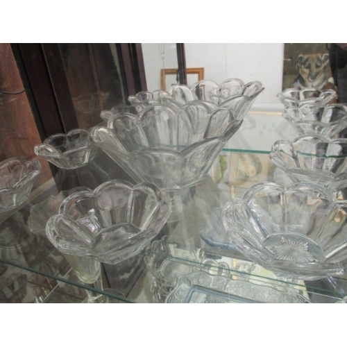 41 - 4 SHELVES OF GLASS BUTTER DISHES, FRUIT DISHES, VASES ETC