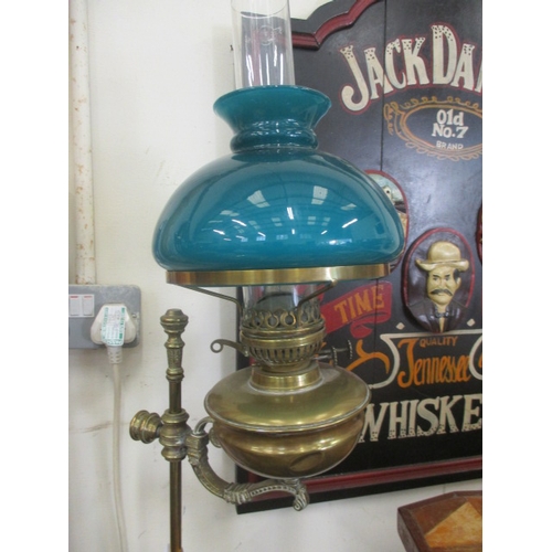 83 - VINTAGE RISE AND FALL BRASS OIL LAMP WITH TEAL COLOURED GLASS SHADE