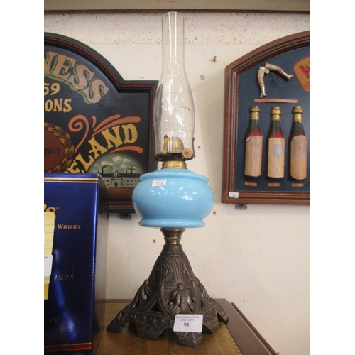 94 - VINTAGE OIL LAMP WITH BLUE CUSTARD GLASS AND  CAST BASE