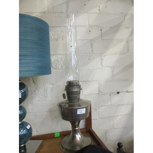 146 - LARGE ART DECO OIL LAMP WITH SILVER METAL BODY AND CLEAR CLASS CHIMNEY