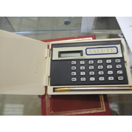 14 - SALUTE CALCULATOR SET IN A SILVER METAL CASE WORKING