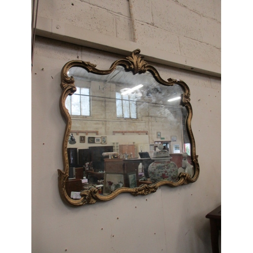 107 - LARGE ORNATE GOLD COLOURED FRAMED MIRROR