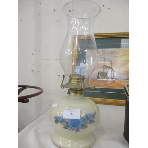 106 - A GLASS BASE WITH FLORAL PATTERN OIL LAMP AND CLEAR GLASS CHIMNEY