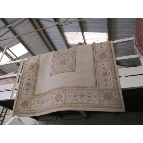 133 - LARGE BEIGE PATTERNED RUG/CARPET