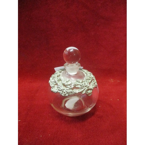 56 - ROUND GLASS PERFUME BOTTLE AND STOPPER WITH SILVER METAL DETAIL