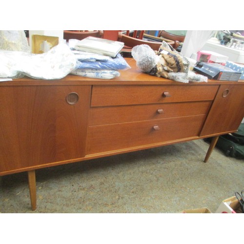 248 - TEAK SIDE BOARD WITH CUPBOARD WITH SLIDING DOORS EITHER SIDE OF THREE DRAWERS BY AVALON