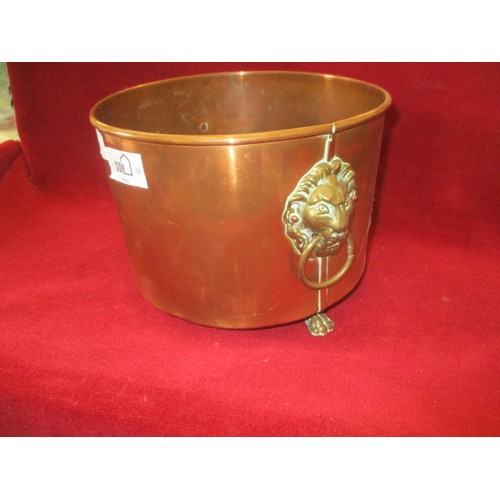 104 - COPPER PLANTER ON BRASS FEET  WITH BRASS LION HEAD HANDLES