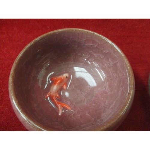 47 - TWO CHINESE HAND PAINTED AND GLAZED TEA BOWLS WITH EMBOSSED GOLD FISH