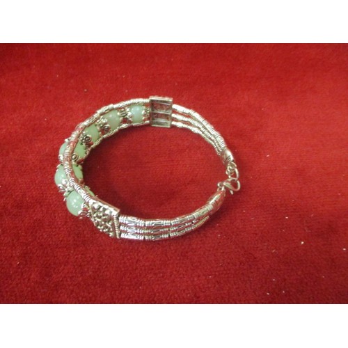 61 - CHINESE/TIBETAN MIAO SILVER BANGLE WITH INSET NATURAL GREEN JADE