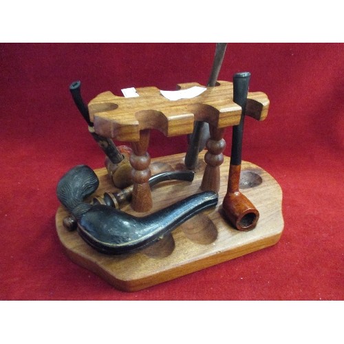 19 - COLLECTION OF PIPES WITH A WOODEN PIPE STAND - INCLUDES PIPE WITH AMBER MOUTH PIECE IN A FITTED CASE