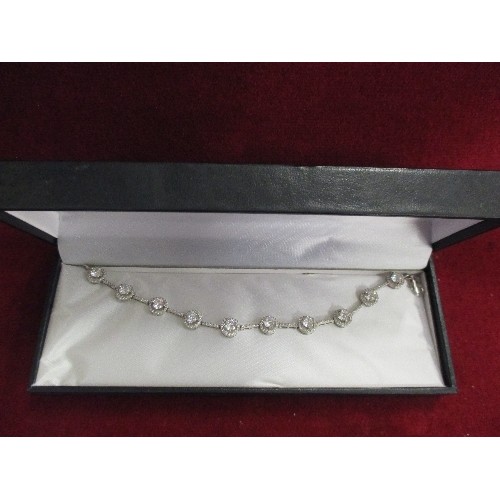 38 - AN ELEGANT SILVER HALLMARKED BRACELET SET WITH HALO SET WHITE STONES - WITH BOX