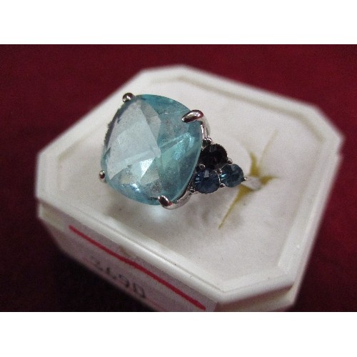 19 - COCKTAIL RING WITH LARGE PALE BLUE SQUARE CUT CENTRAL CRYSTAL FLANKED BY PURPLE AND BLUE COLOURED ST... 