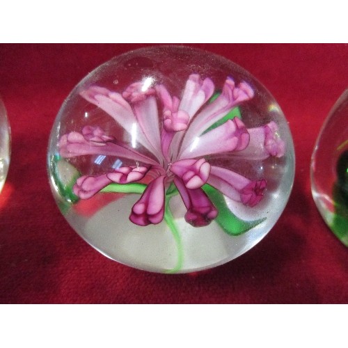 3 - 4 CLEAR GLASS PAPERWEIGHTS - 1 WITH GREEN SPIRAL, 1 WITH CLEAR BUBBLES, 1 WITH FLOWER AND 1 PLAIN