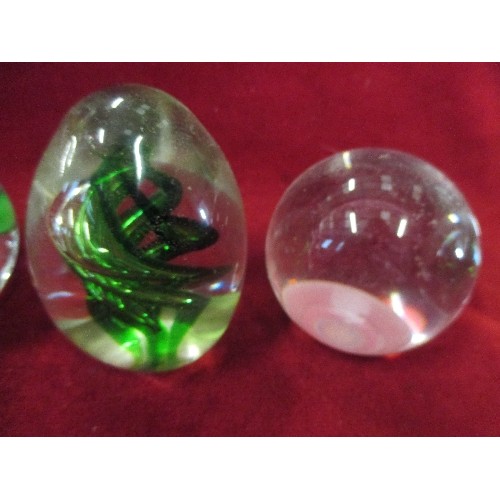 3 - 4 CLEAR GLASS PAPERWEIGHTS - 1 WITH GREEN SPIRAL, 1 WITH CLEAR BUBBLES, 1 WITH FLOWER AND 1 PLAIN