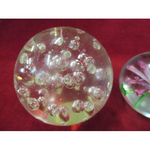 3 - 4 CLEAR GLASS PAPERWEIGHTS - 1 WITH GREEN SPIRAL, 1 WITH CLEAR BUBBLES, 1 WITH FLOWER AND 1 PLAIN