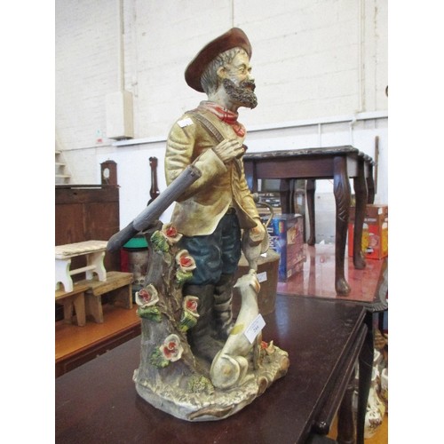 178 - LARGE POTTERY FIGURE OF HUNTER WITH HIS DOG AND GUN- 54CM HIGH