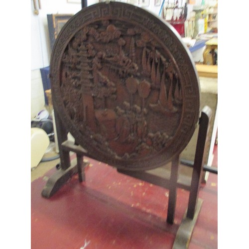 401 - 1930'S ORIENTAL HARDWOOD TABLE FIRESCREEN, THE TOP DEEPLY CARVED WITH FIGURES AND LANDSCAPE - DIA 60... 