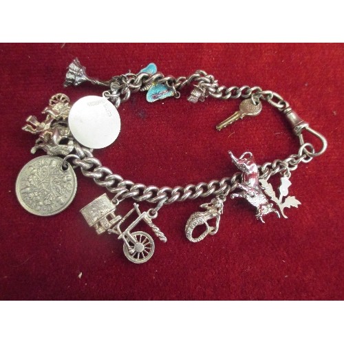 34 - STERLING SILVER CHARM BRACELET WITH SILVER CHARMS INCLUDING ENAMEL BUTTERFLY, BULL, SPINNING WHEEL E... 