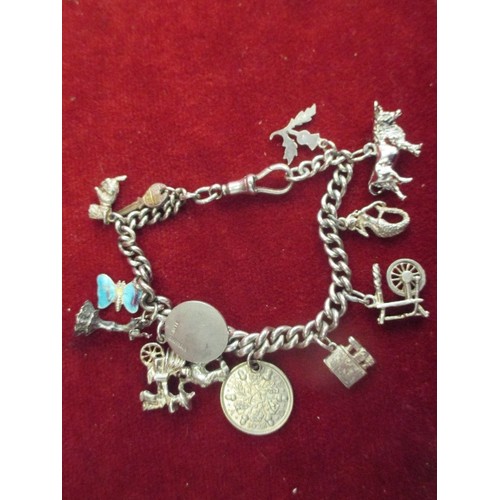 34 - STERLING SILVER CHARM BRACELET WITH SILVER CHARMS INCLUDING ENAMEL BUTTERFLY, BULL, SPINNING WHEEL E... 