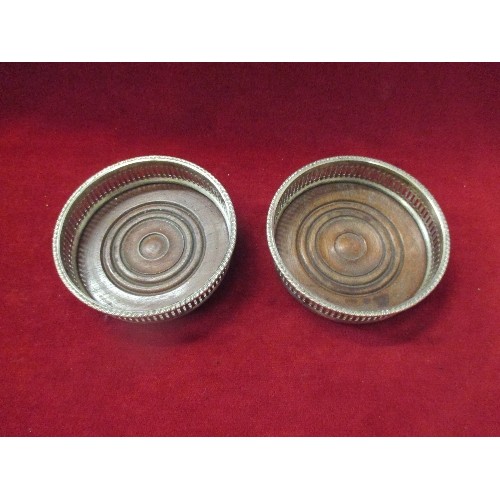 132 - PAIR VINTAGE SILVER ON COPPER WINE BOTTLE COASTERS WITH TURNED MAHOGANY BASES