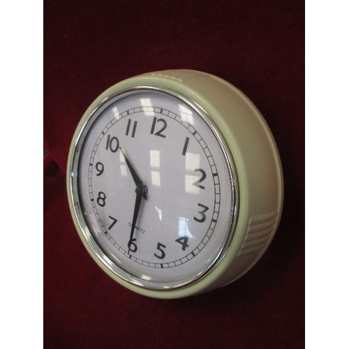 115 - RETRO BATTERY OPERATED CLOCK WITH CREAM SURROUND.