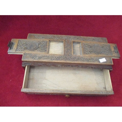 132 - OLD CARVED WOODEN BOX, WITH DRAWER, AND 2 SLIDING PANELS ON THE LID. 29CM L.