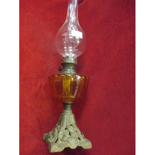 246 - VINTAGE OIL LAMP WITH FLUTED AMBER RESERVOIR, WROUGHT IRON BASE. COMPLETE WITH CHIMNEY/GLASS.