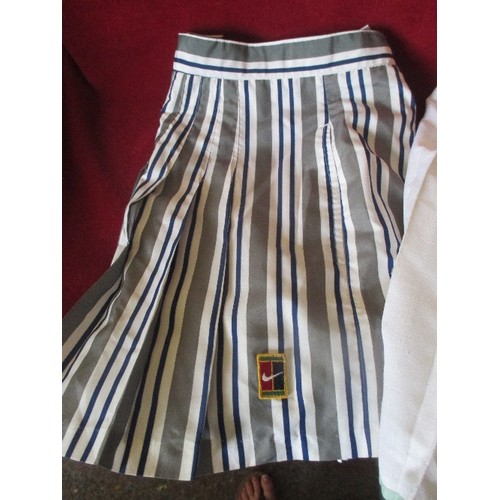 105 - 2 VINTAGE RETRO TENNIS SKIRTS, INCLUDES A STRIPED NIKE, AND A WHITE SLAZENGER.