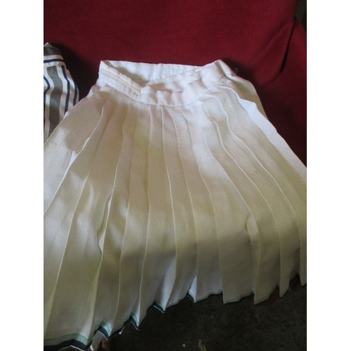 105 - 2 VINTAGE RETRO TENNIS SKIRTS, INCLUDES A STRIPED NIKE, AND A WHITE SLAZENGER.