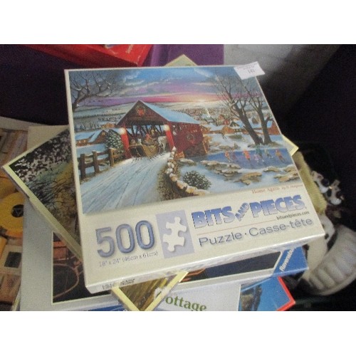 142 - STACK OF JIGSAW PUZZLES. 1000 AND 500 PIECE. GOOD CLEAN CONDITION.