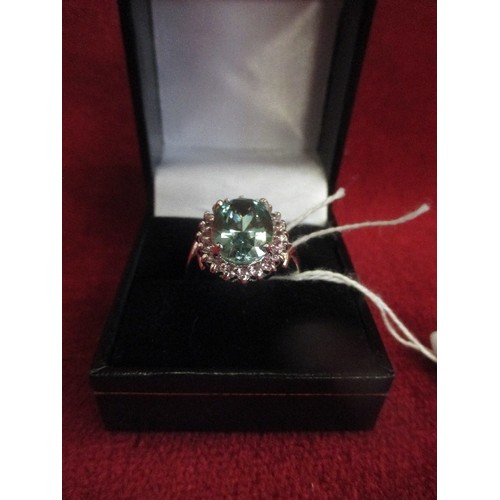 26 - A STUNNING 925 SILVER DRESS RING SET WITH A LARGE PALE GREEN STONE (14MM X 10MM) - SURROUNDED BY CZ ... 