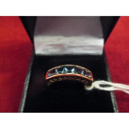 27 - A 9CT GOLD RING WITH RAISED GALLERY SET WITH 5 CUSHION CUT BLUE TOPAZ STONES - 3.3 GRAMS