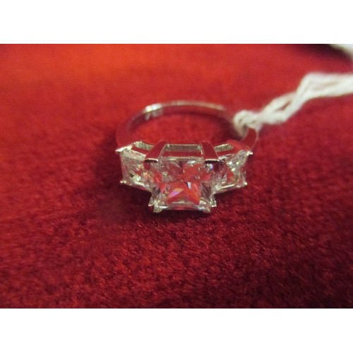 48 - A 925 SILVER RING SET WITH A LARGE DIAMONIQUE CUBIC ZIRCONIA FLANKED BY TWO SMALLER STONES - CUSHION... 