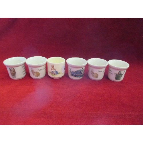 14 - SIX EGG CUPS INC FOUR WEDGWOOD BEATRIX POTTER  COMPRISING 3 X PETER RABBIT WITH WATERING CAN AND 1 X... 