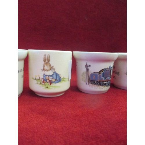 14 - SIX EGG CUPS INC FOUR WEDGWOOD BEATRIX POTTER  COMPRISING 3 X PETER RABBIT WITH WATERING CAN AND 1 X... 