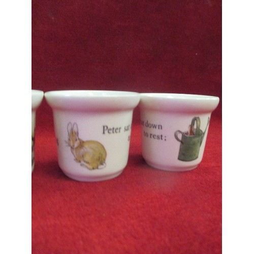 14 - SIX EGG CUPS INC FOUR WEDGWOOD BEATRIX POTTER  COMPRISING 3 X PETER RABBIT WITH WATERING CAN AND 1 X... 