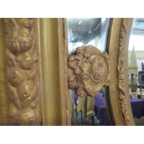 210 - A LARGE AND IMPRESSIVE EMPIRE STYLE GILT FRAMED WALL MIRROR - THE CARVED AND MOULDED FRAME WITH FRUI... 