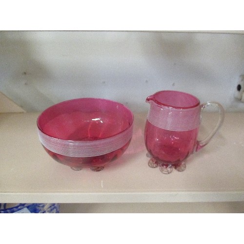 179 - A VICTORIAN CRANBERRY GLASS MILK JUG AND SUGAR BOWL WITH WHITE TRAILING AND PETAL FEET - JUG 10CM H,... 